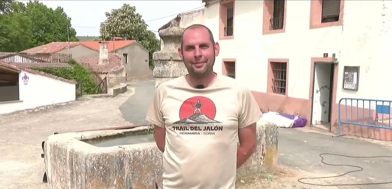 Fernando del Amo con la camiseta del Trail del Jalón junto al pilón de una calle de Benamira