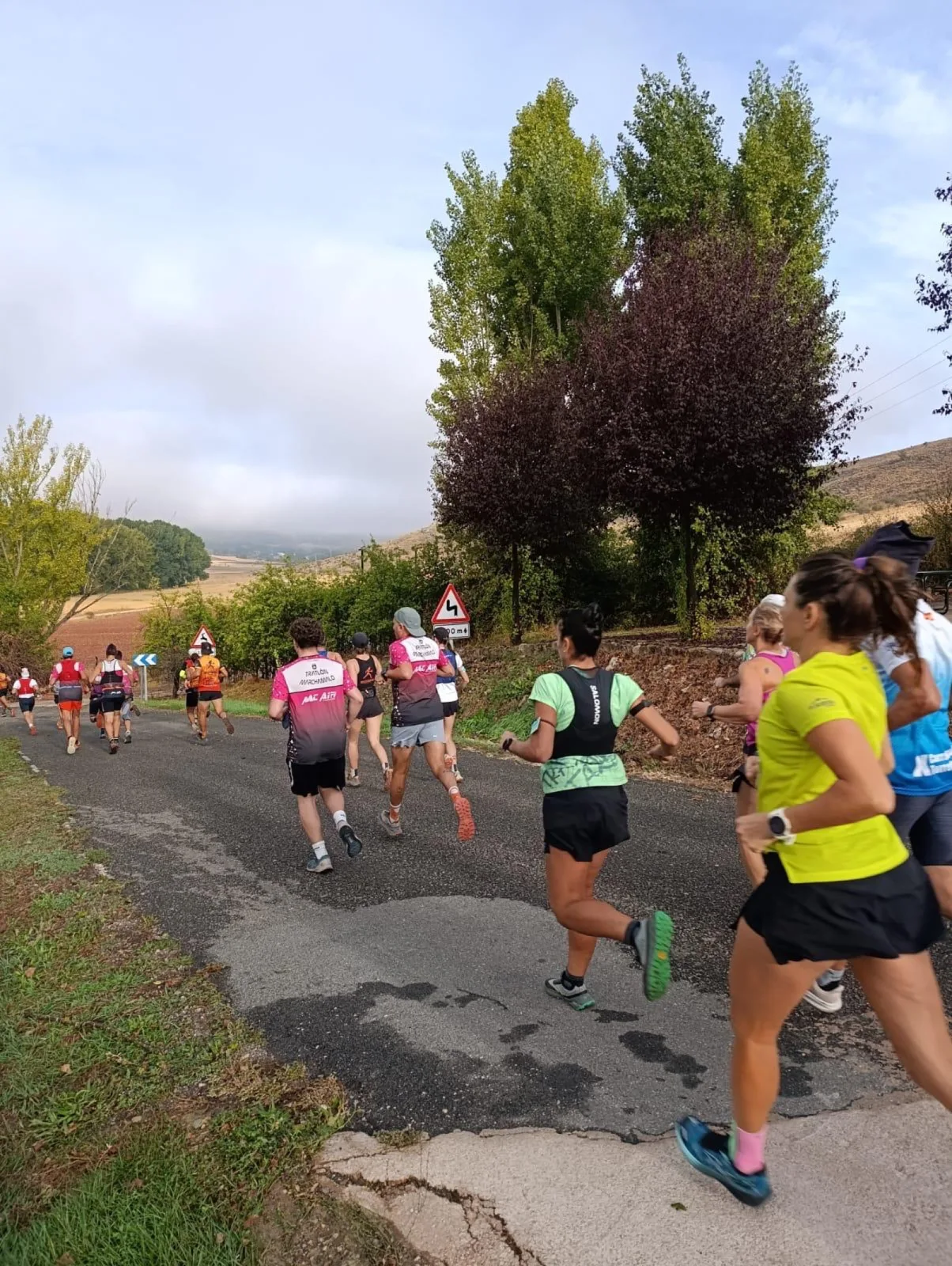 Grupo de corredores por la carretera a la salida del pueblo